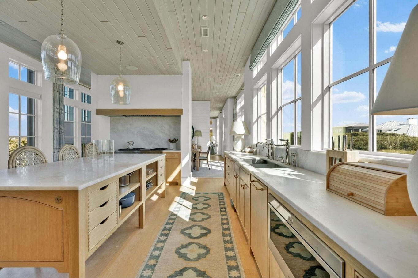 Light-filled chef's kitchen with an island and marsh view
