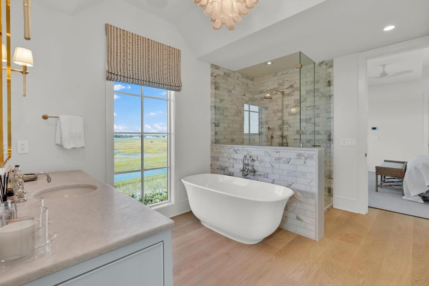 Owners' bath with freestanding tub, marble shower and ocean view