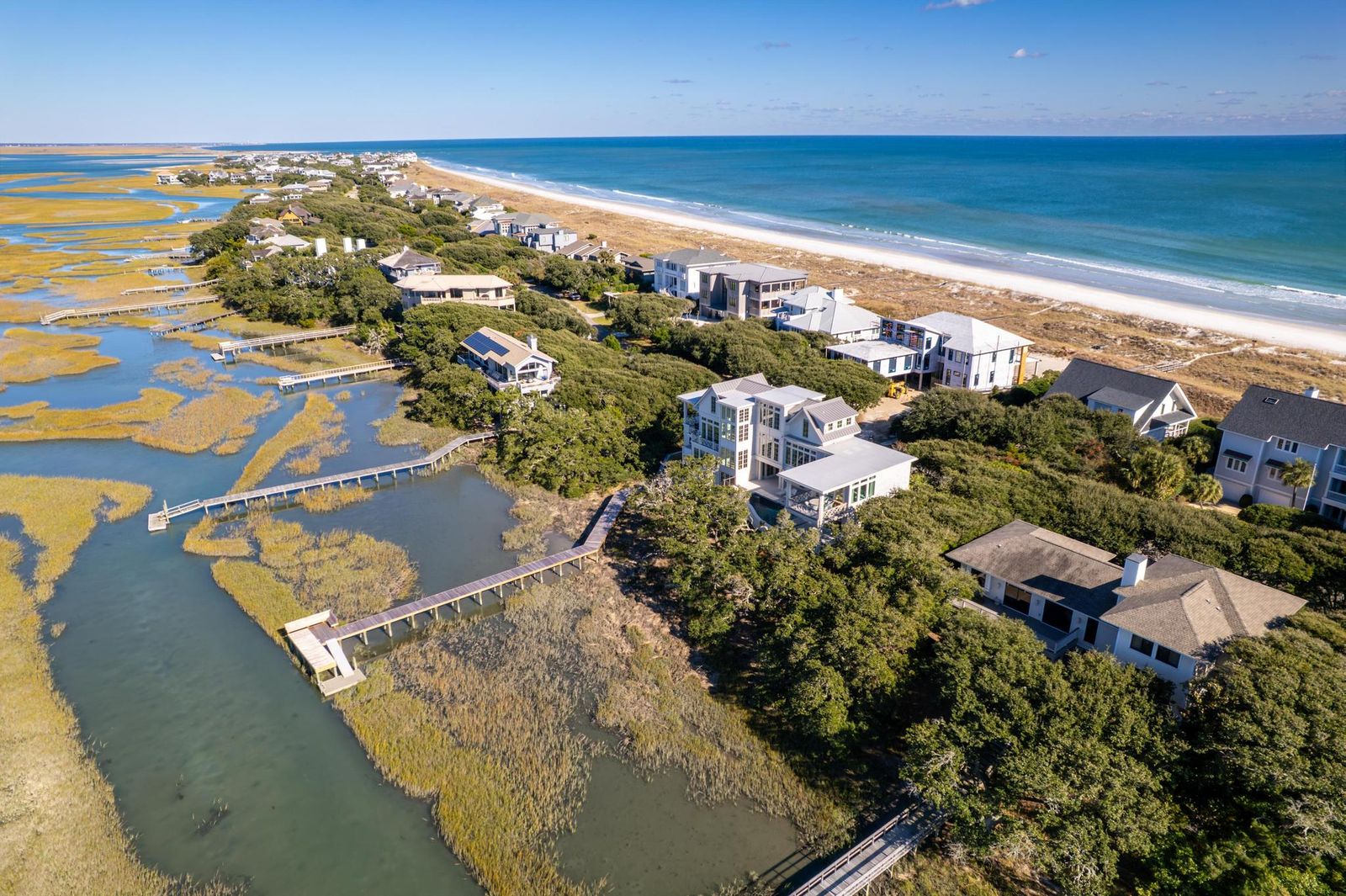 Wide aerial view of the ocean, the residence and its private dock