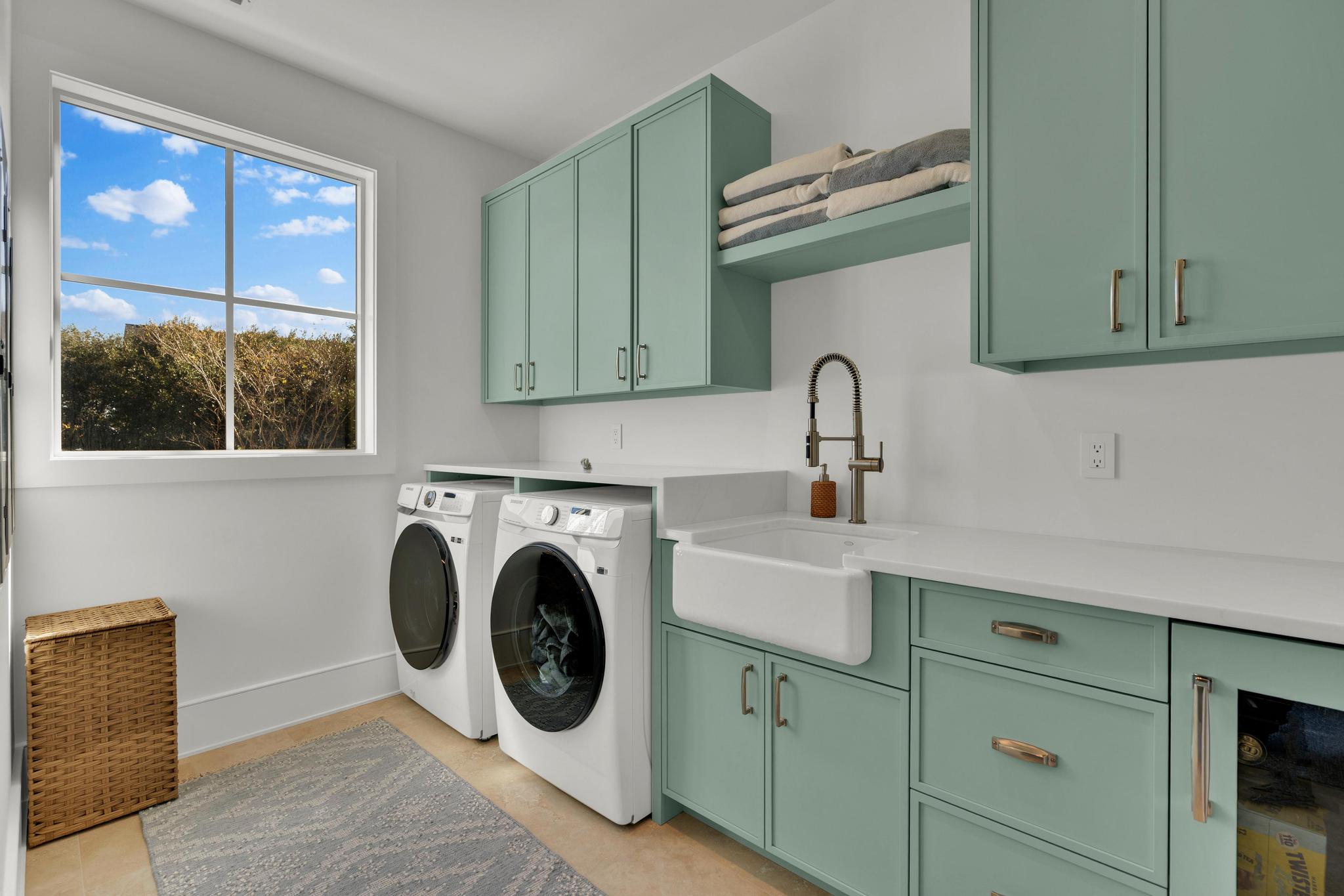 Laundry room with white cabinetry and a farmhouse sink