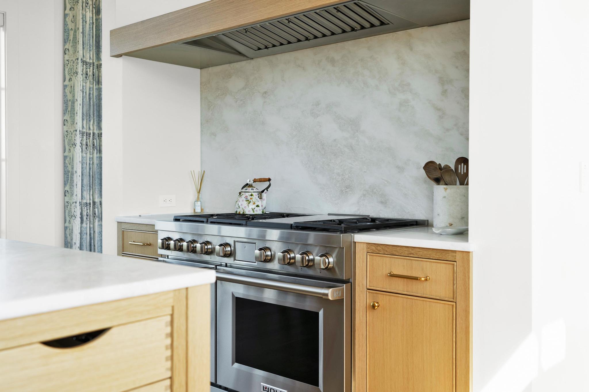 Wolf range with red knobs in the chef's kitchen