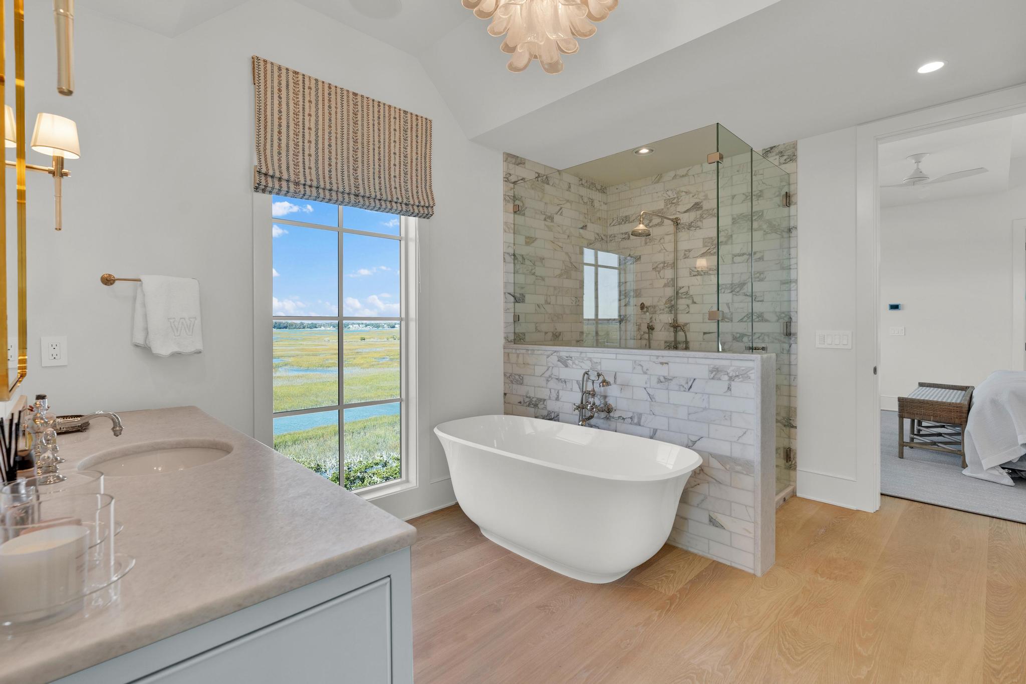Her bath with a freestanding tub and marble shower