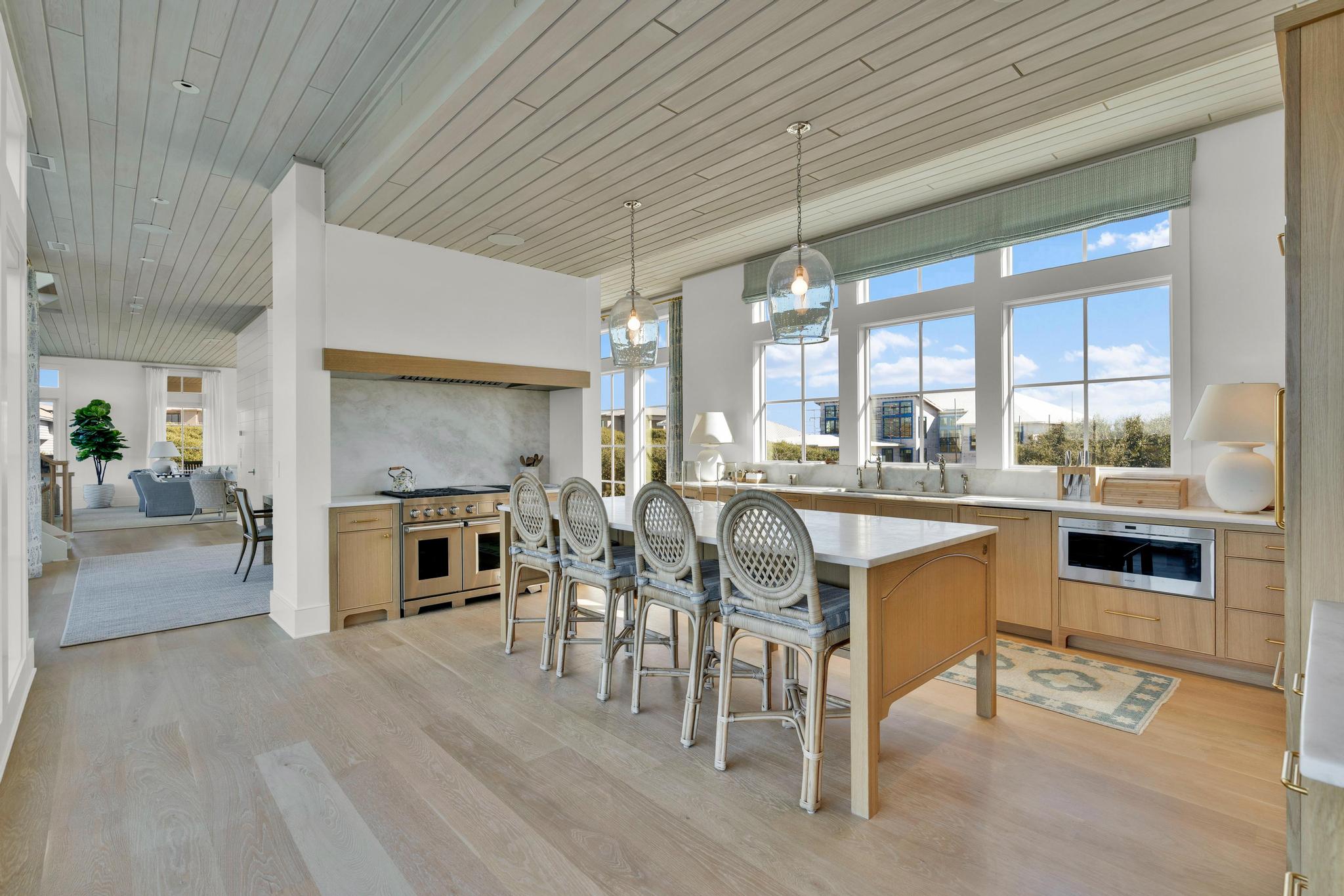 Chef's kitchen with a long island and rattan stools