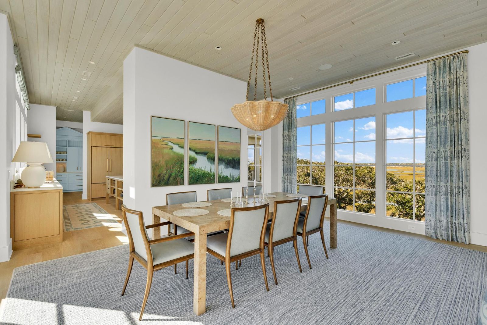 Dining room with a marsh triptych above the sideboard