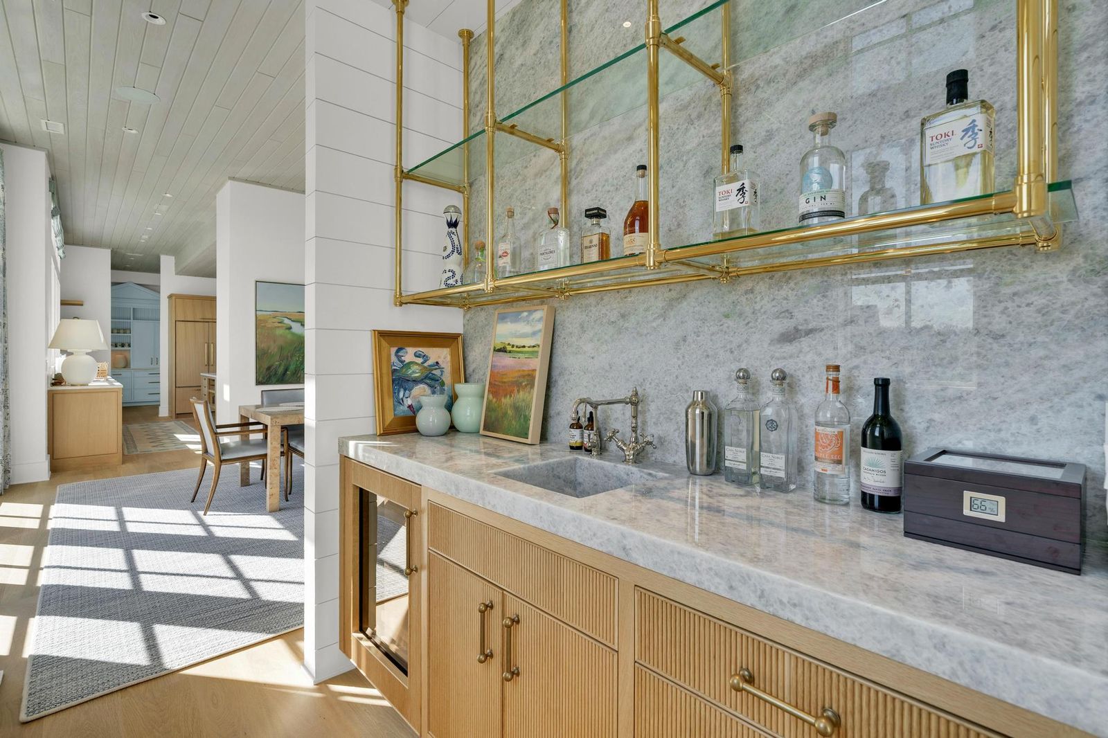 Wet bar with brass-framed glass shelving