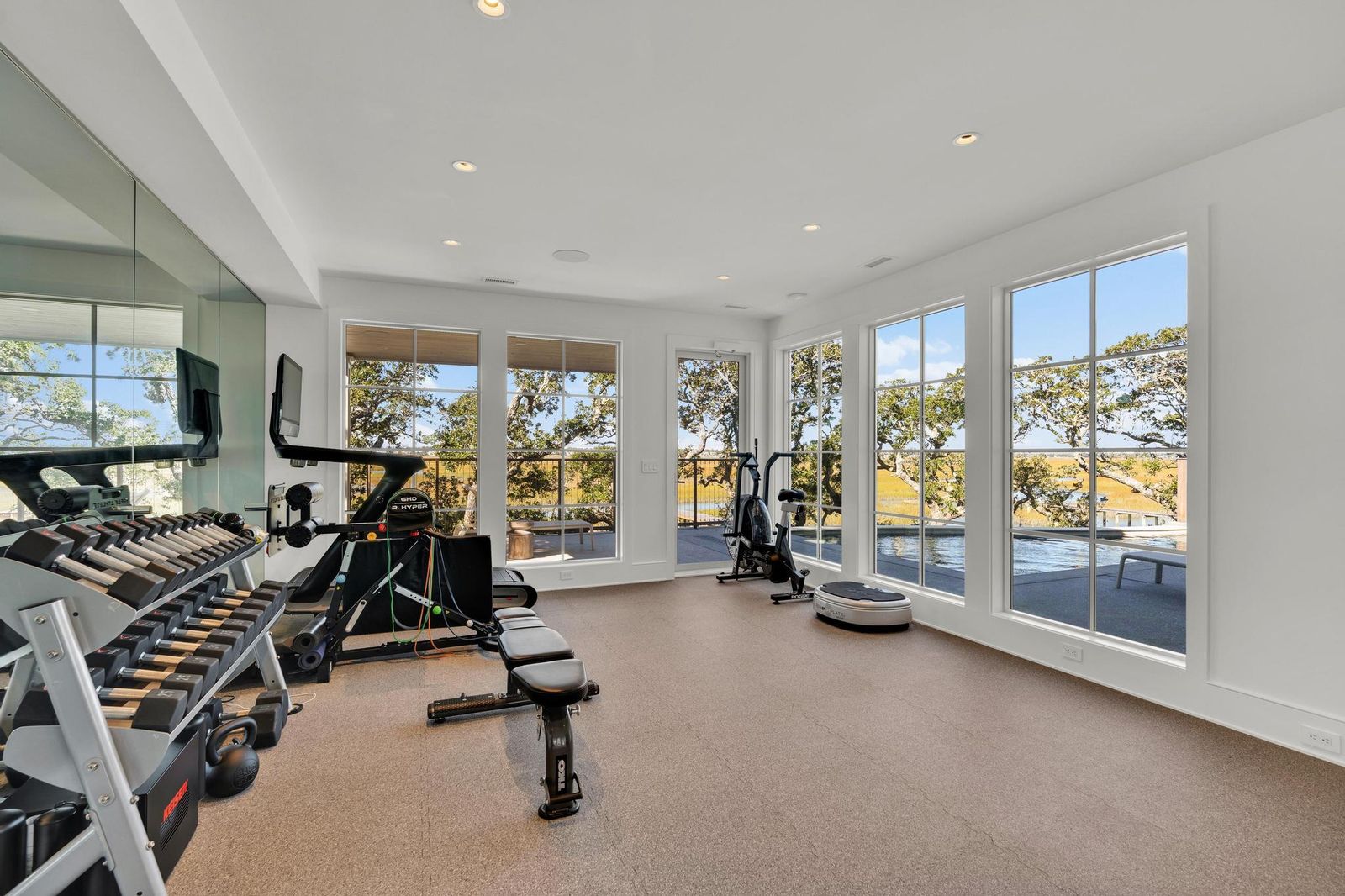 Fitness room surrounded by tall windows