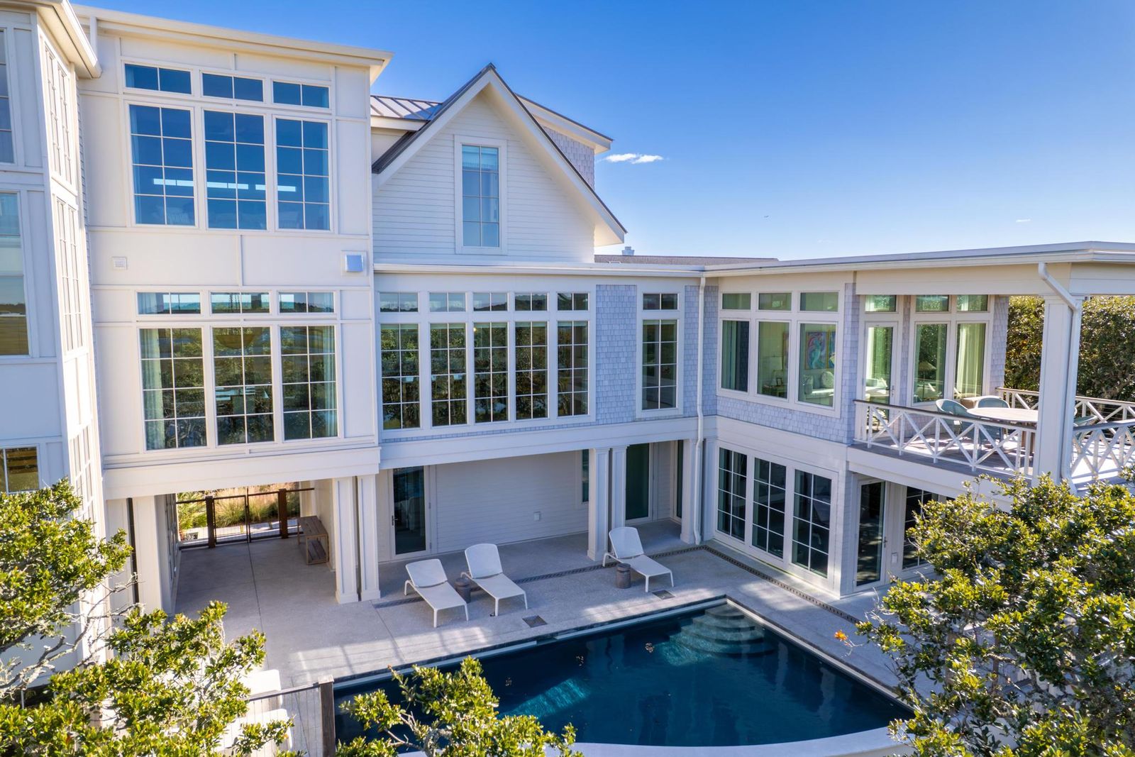 Elevated view over the pool courtyard and live oaks